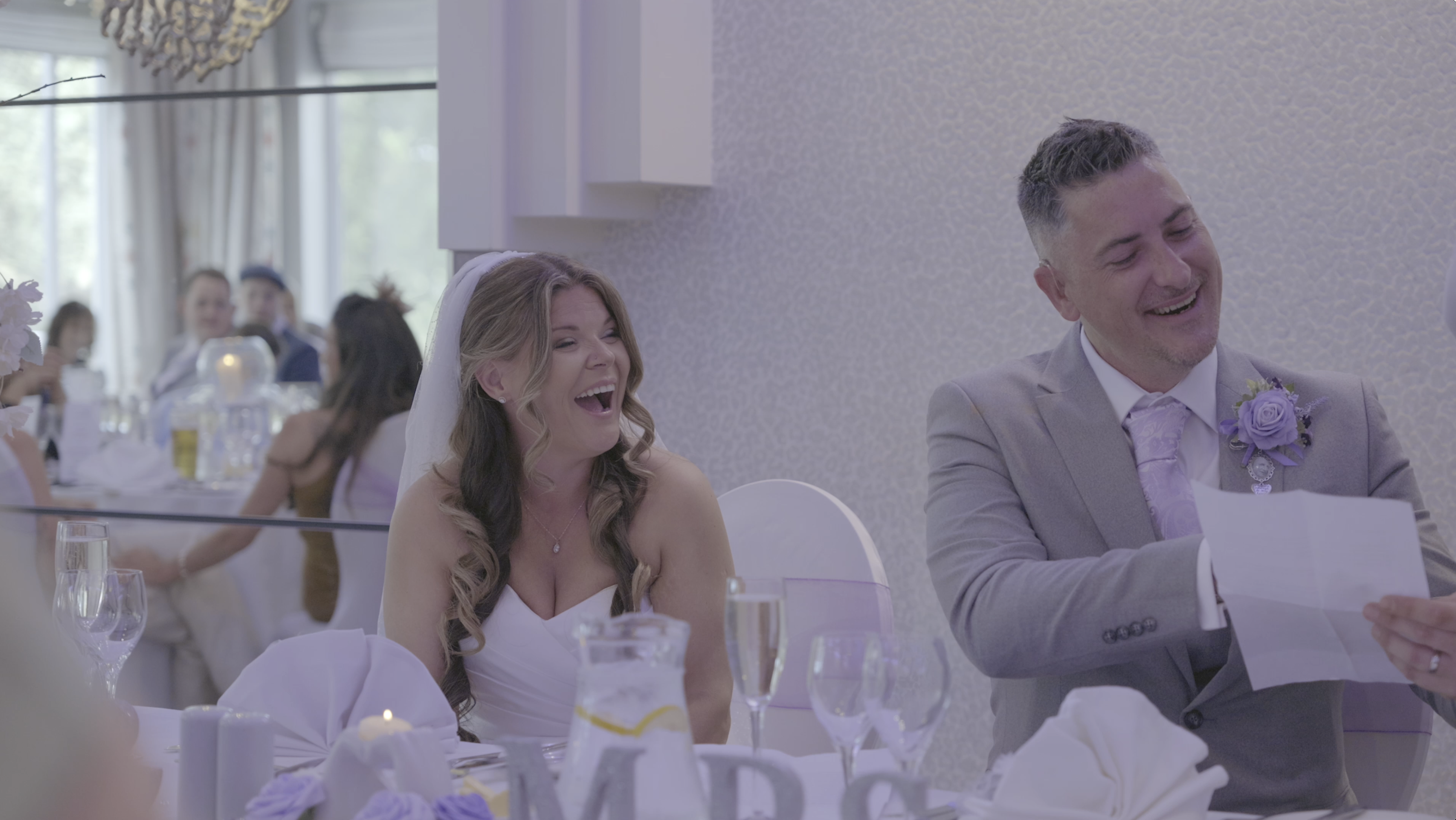 Kirsty and Connor laughing at their Thornton Hall wedding on the Wirral