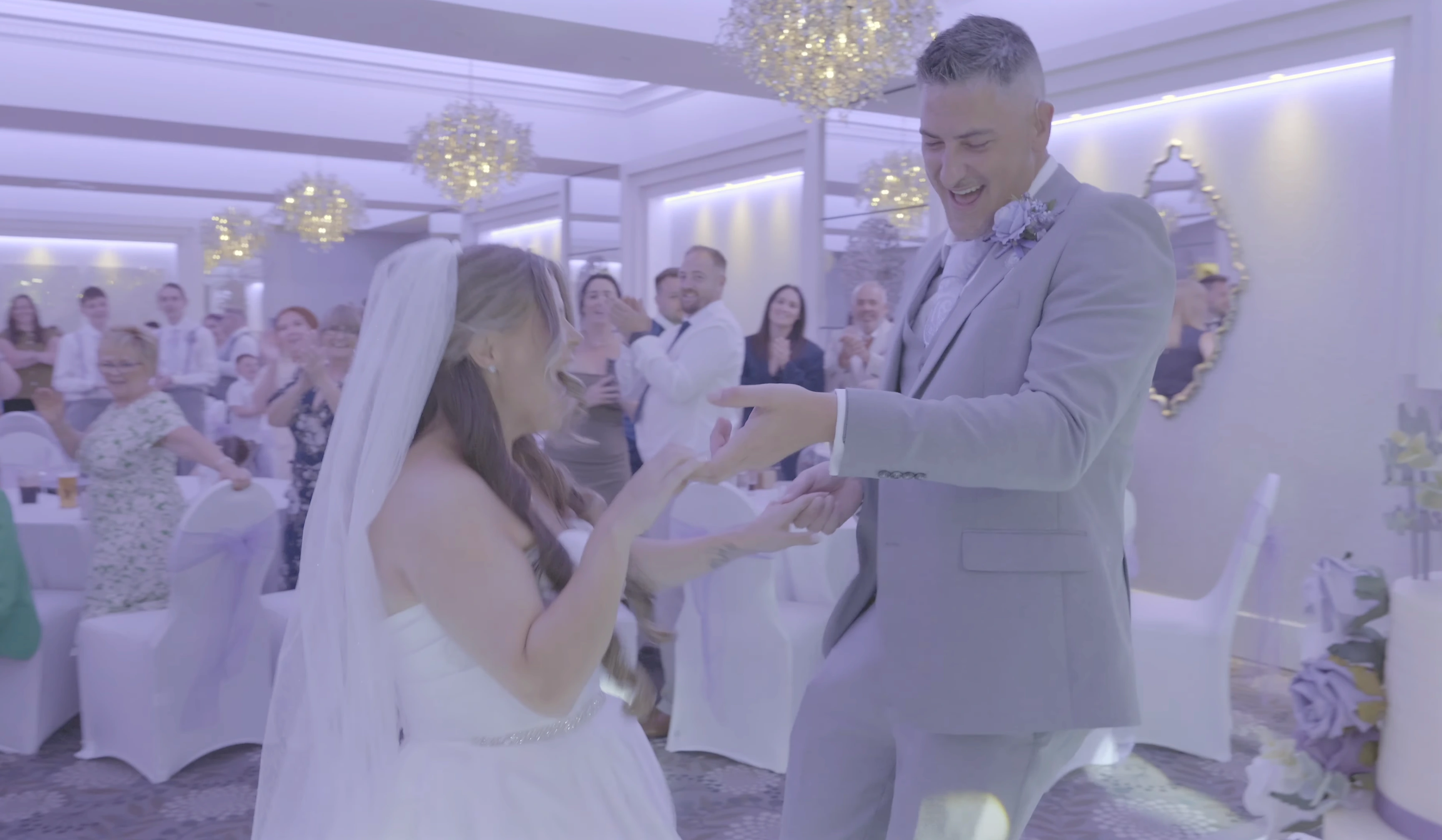 Bride and groom laughing together during their first dance at Thornton Hall on the Wirral