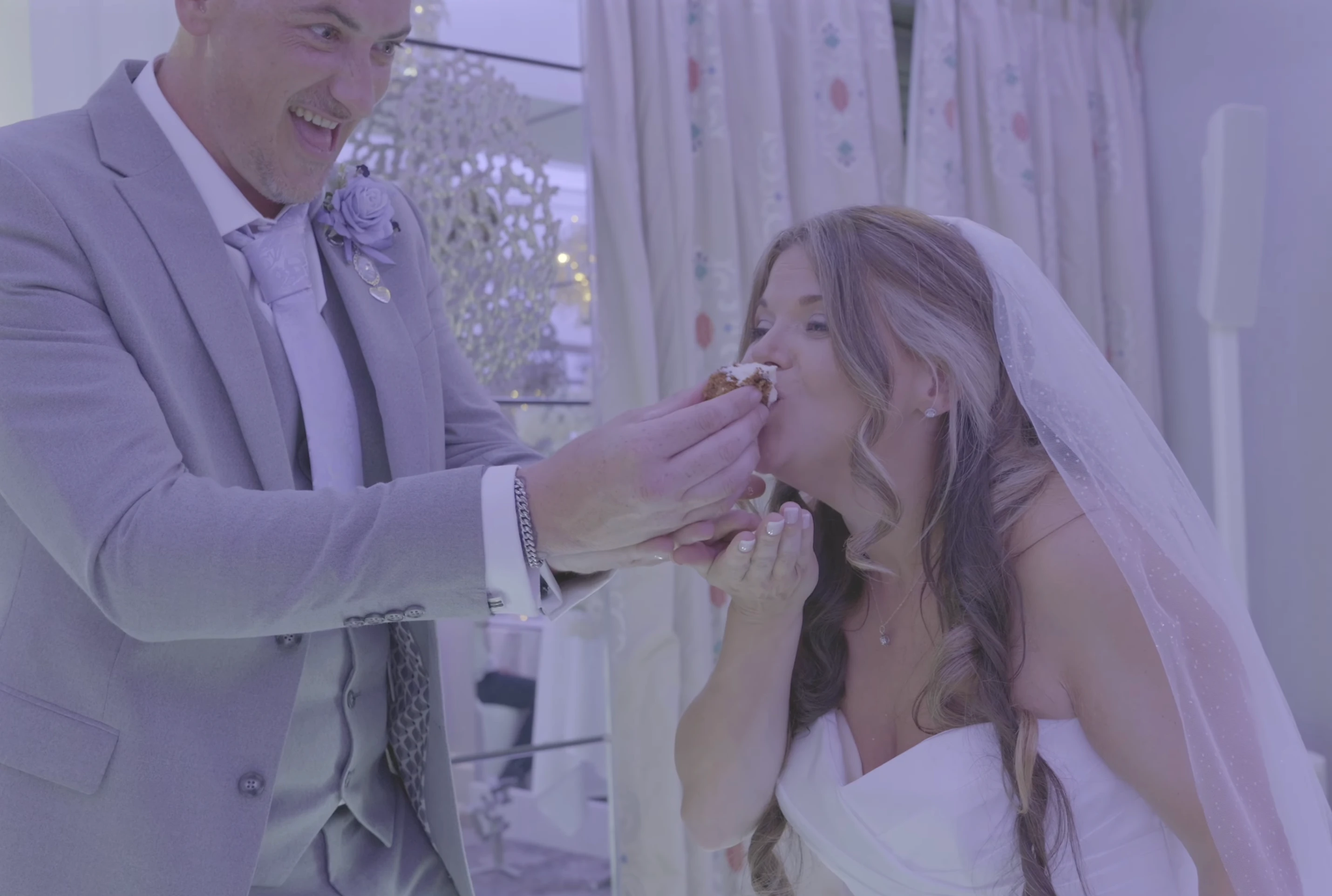 Kirsty and Connor sharing wedding cake at Thornton Hall Hotel on the Wirral